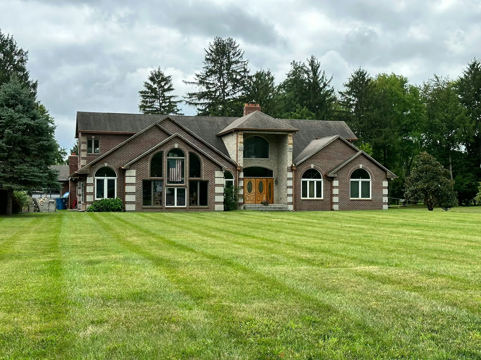 Large two-story house set back behind a wide mowed lawn, illustrating a home appraisal that comes in low for a sale in Taft